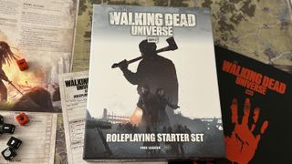 Image of The Walking Dead Universe RPG starter set, with a background of game components like booklets, maps, and dice.